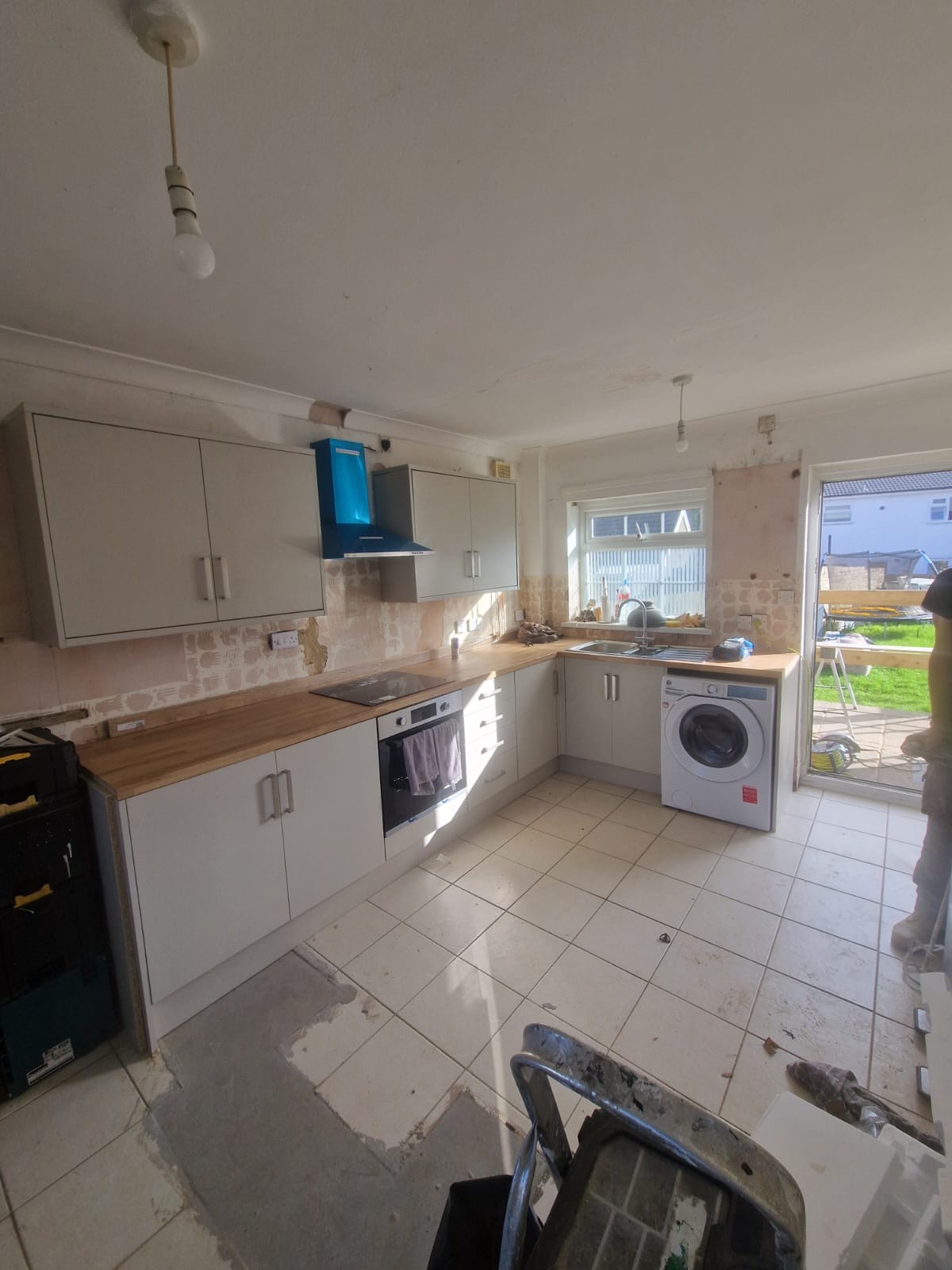 Kitchen during refurbishment with replacement units and worktops installed