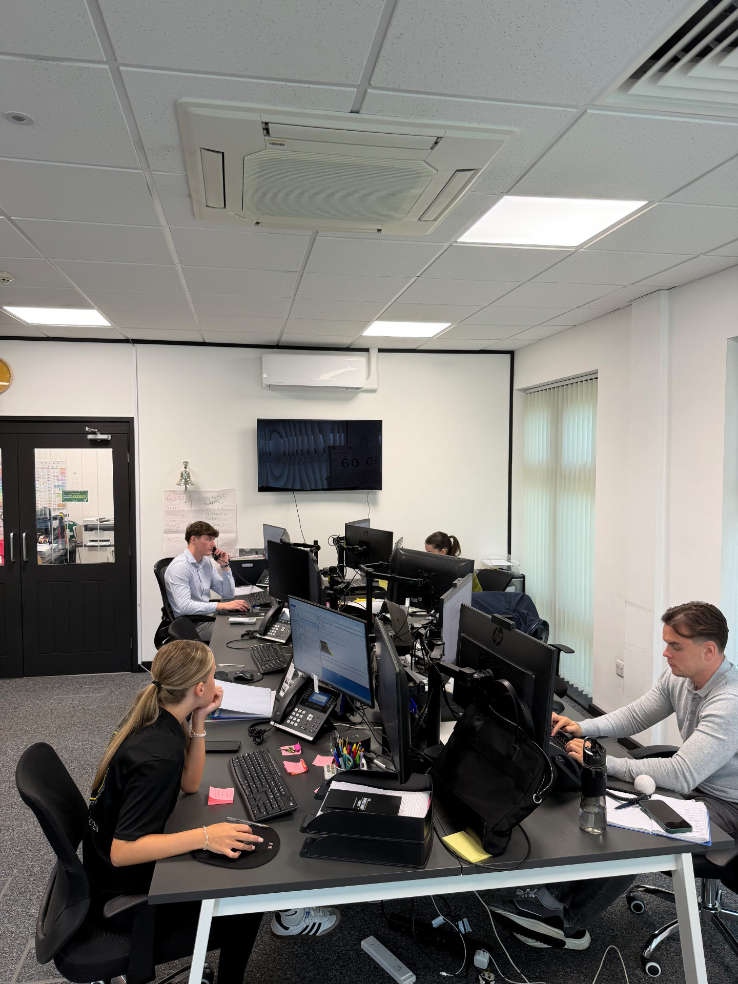 The Invest With Joe team working in the office